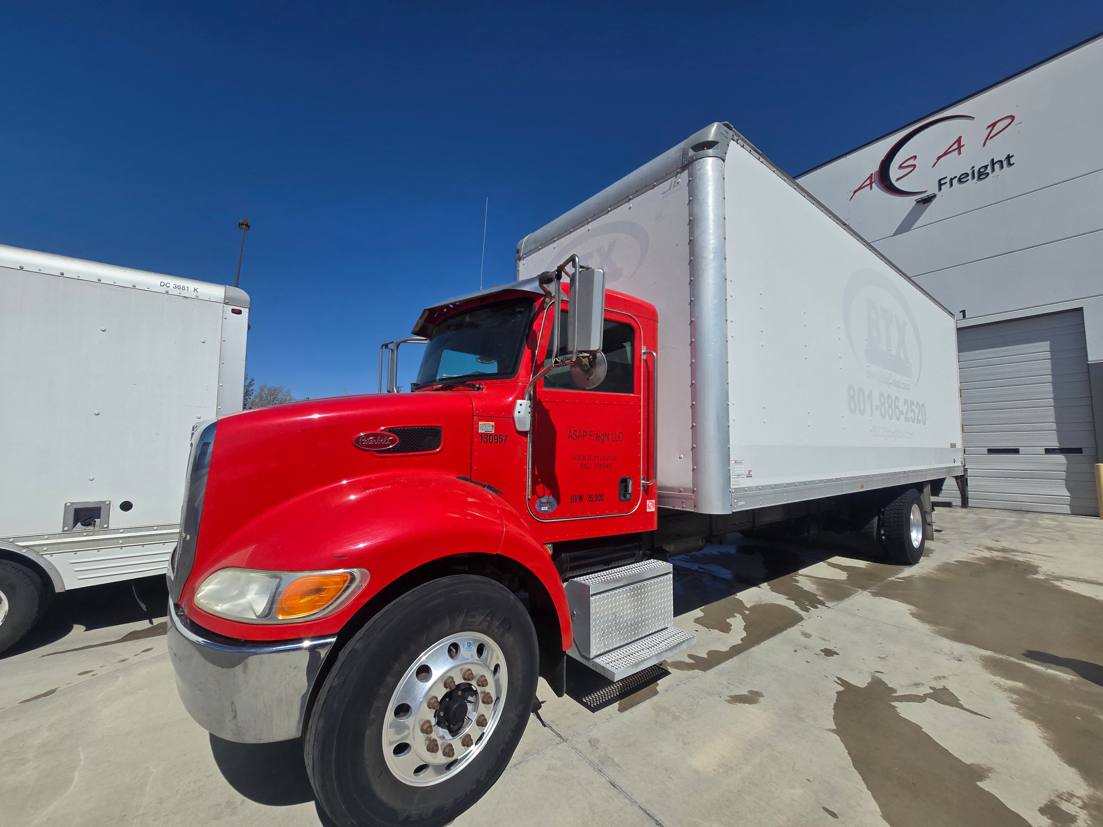 BTX Global Logistics Peterbilt box truck — front three-quarter view after professional decal removal
