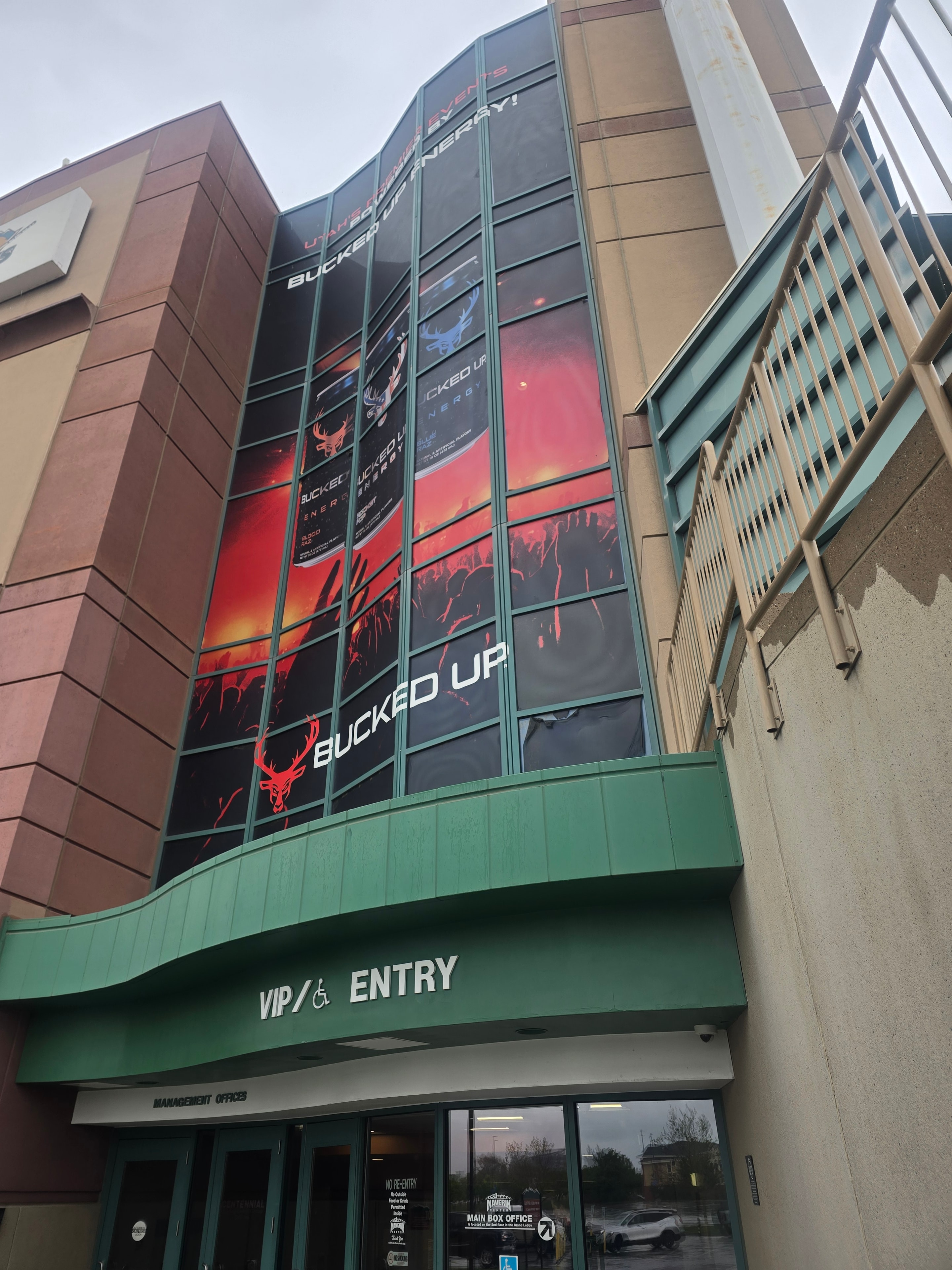 Bucked Up Energy window wrap on Maverick Center glass facade before cleaning — West Valley City, Utah