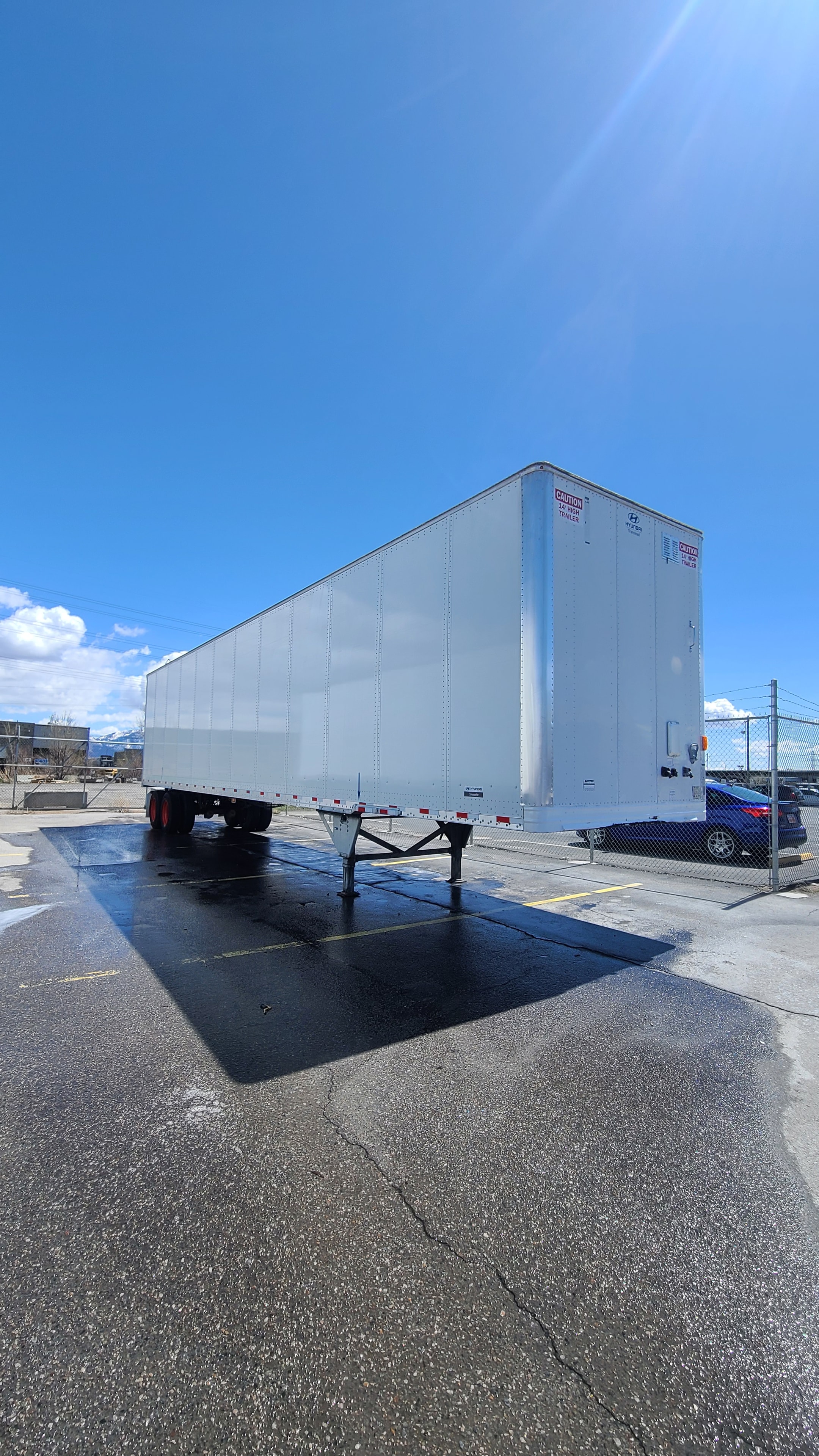 Digby commercial trailer front nose angle after complete fleet de-identification — clean white aluminum panel, zero decals, zero adhesive residue, Utah fleet washing service