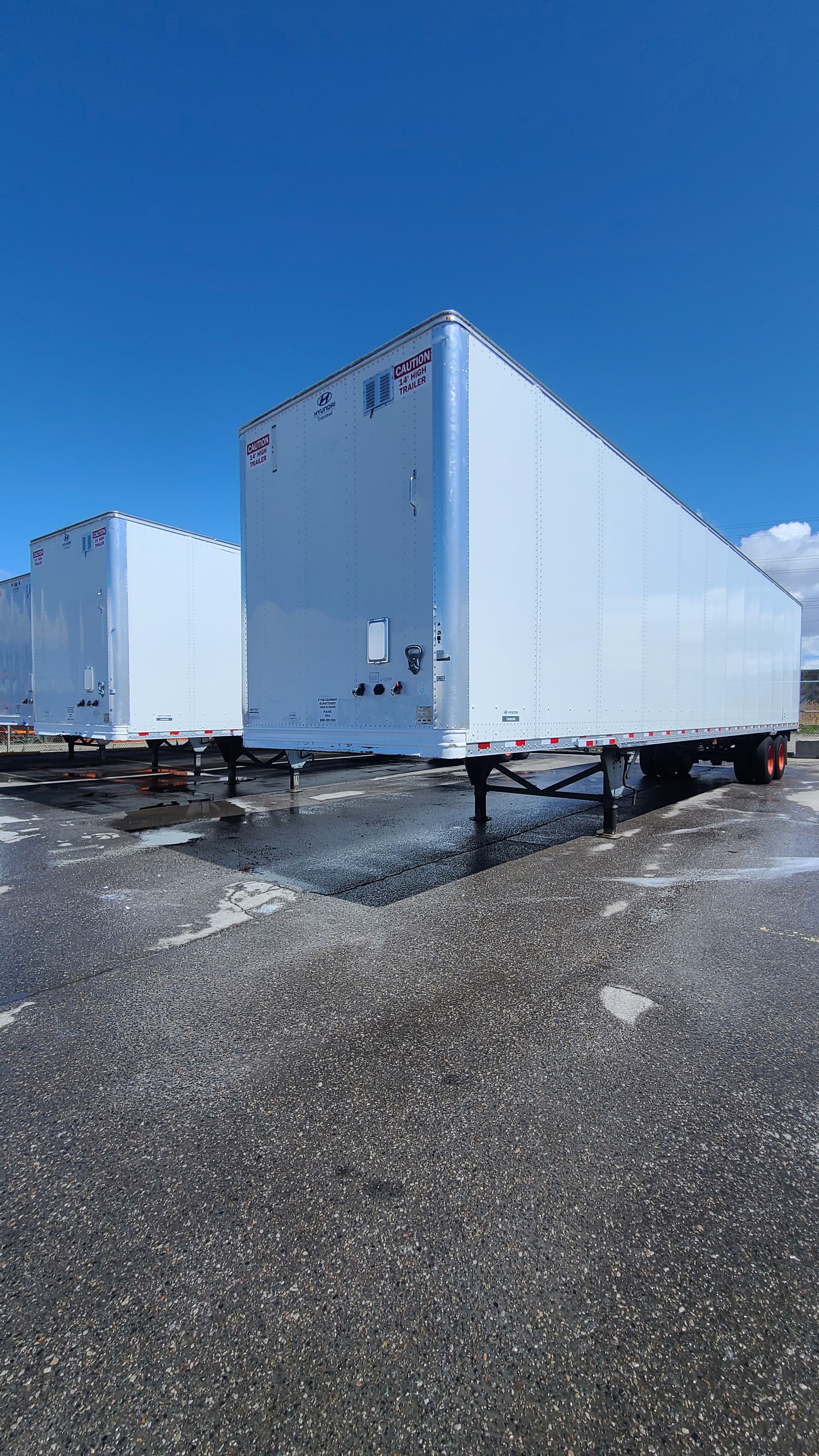 Two Digby pup trailers lined up after complete fleet de-identification — both units fully clean with no graphics or adhesive, commercial trailer restoration Utah