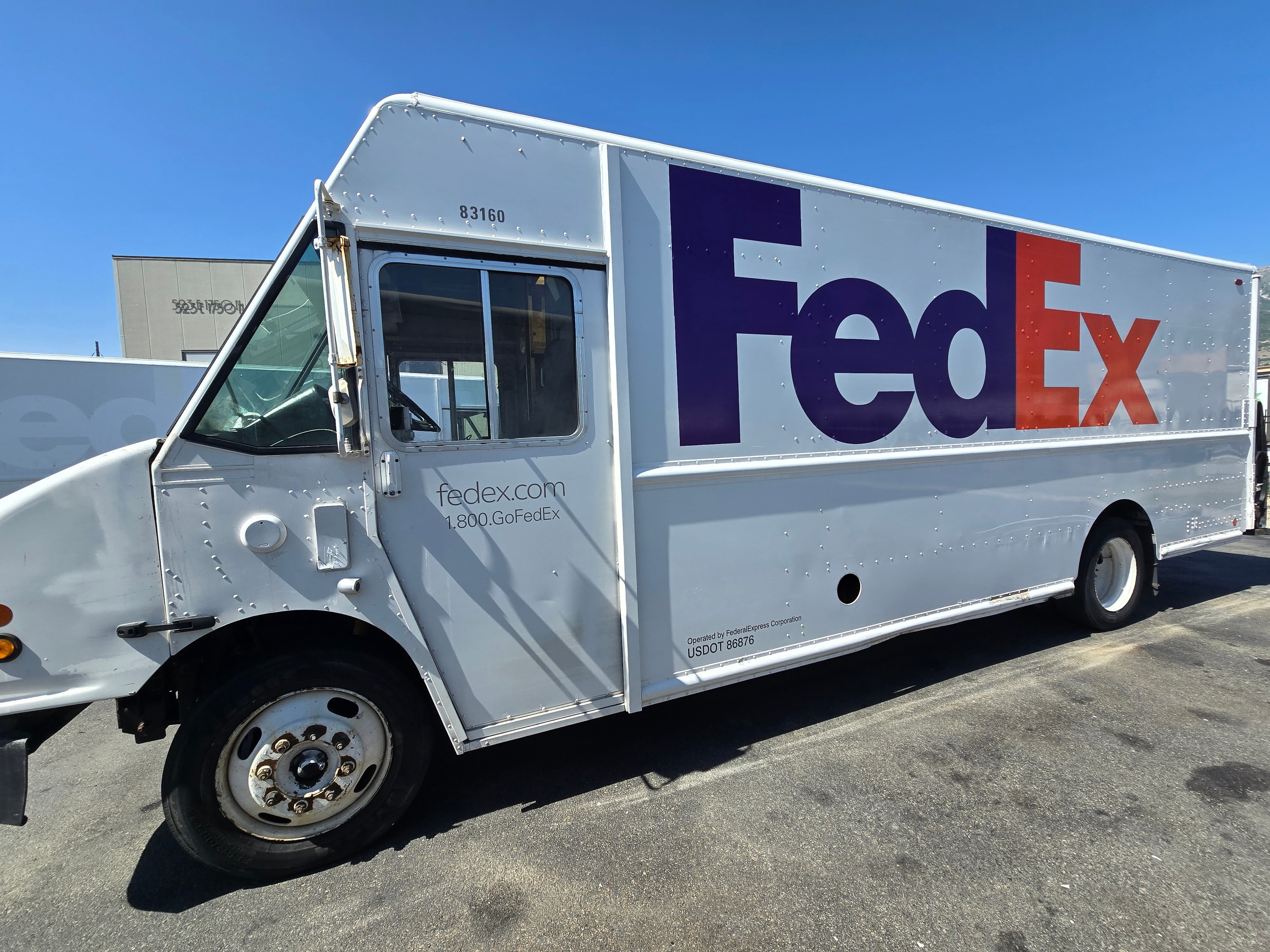 FedEx step van full side profile after de-identification — large format decals removed, Utah fleet rebranding complete