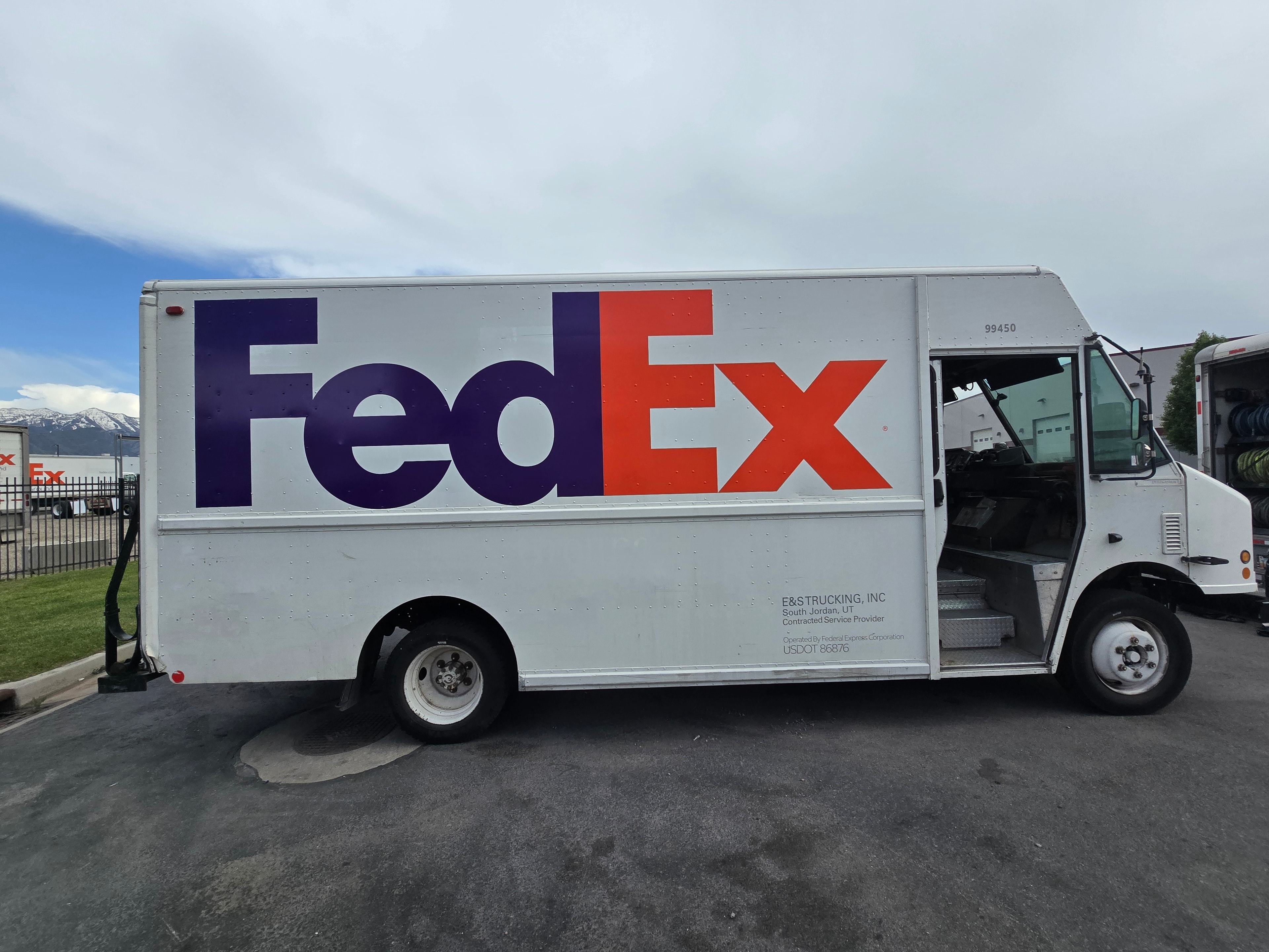 FedEx step van side profile with Utah mountains after de-identification — clean panel after fleet rebranding project