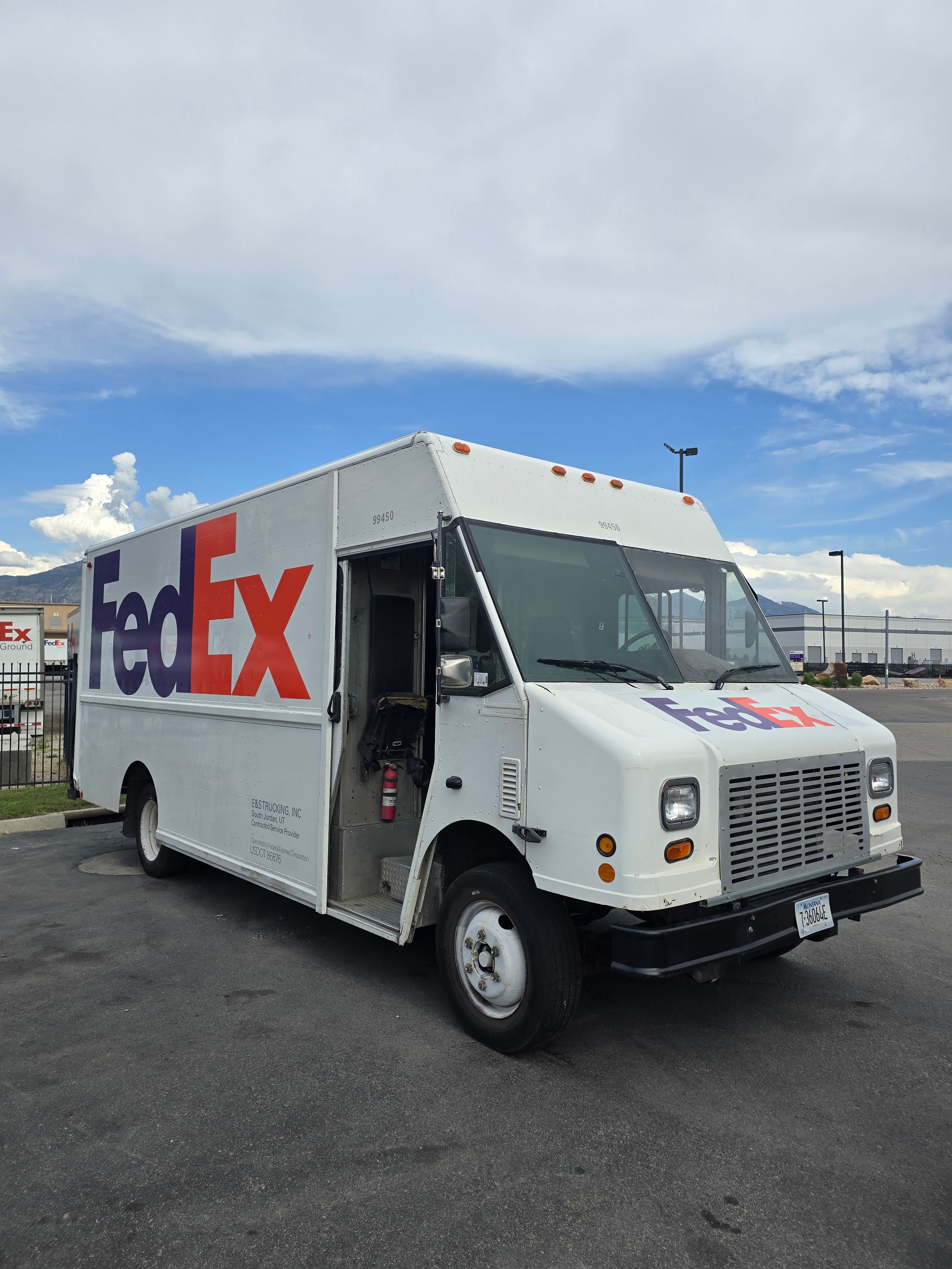 FedEx step van after rebranding — new graphics installed over clean panel, Utah fleet de-identification project