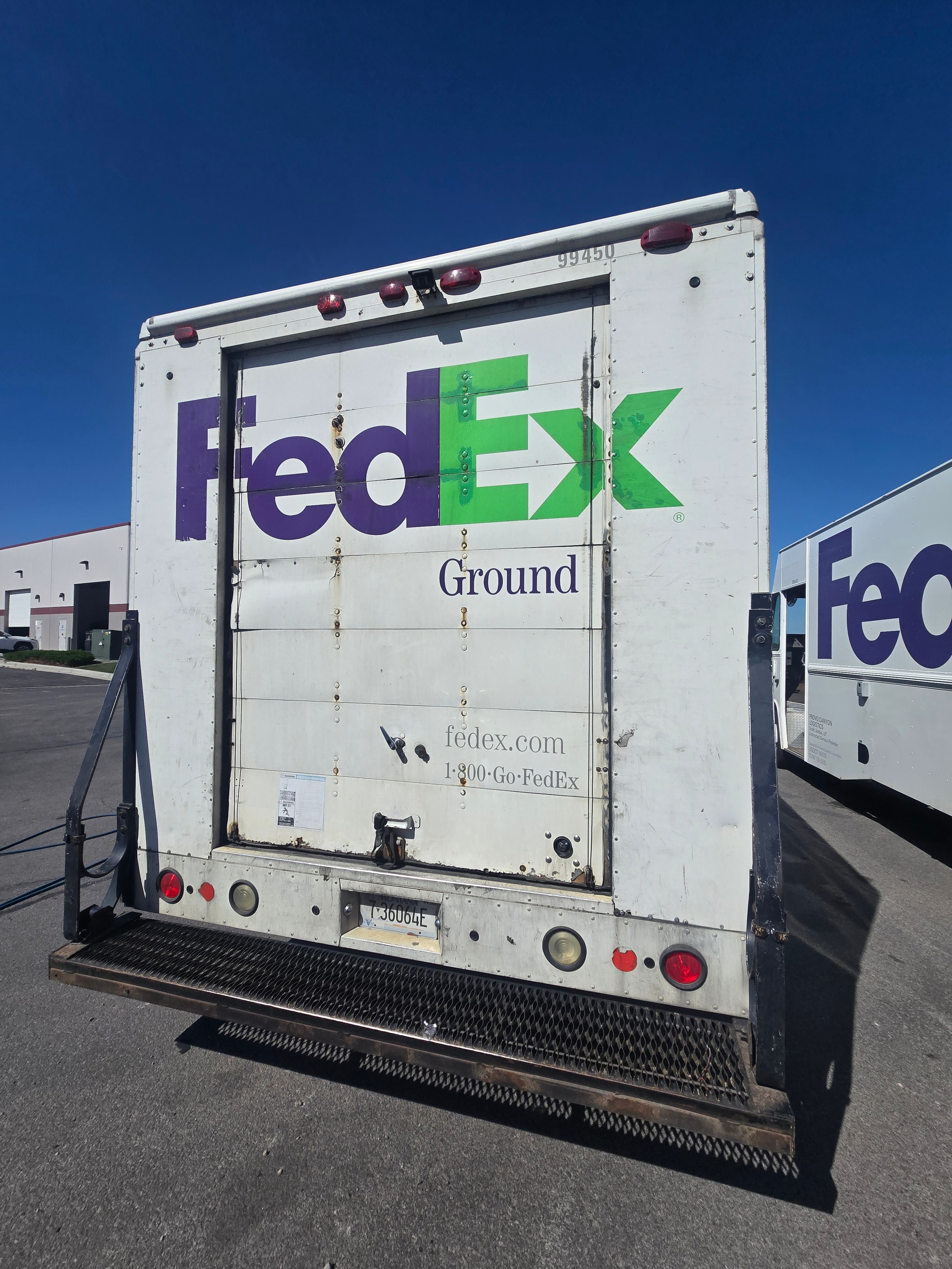 FedEx Ground delivery van rear door — full FedEx Ground logo and contact info before decal removal