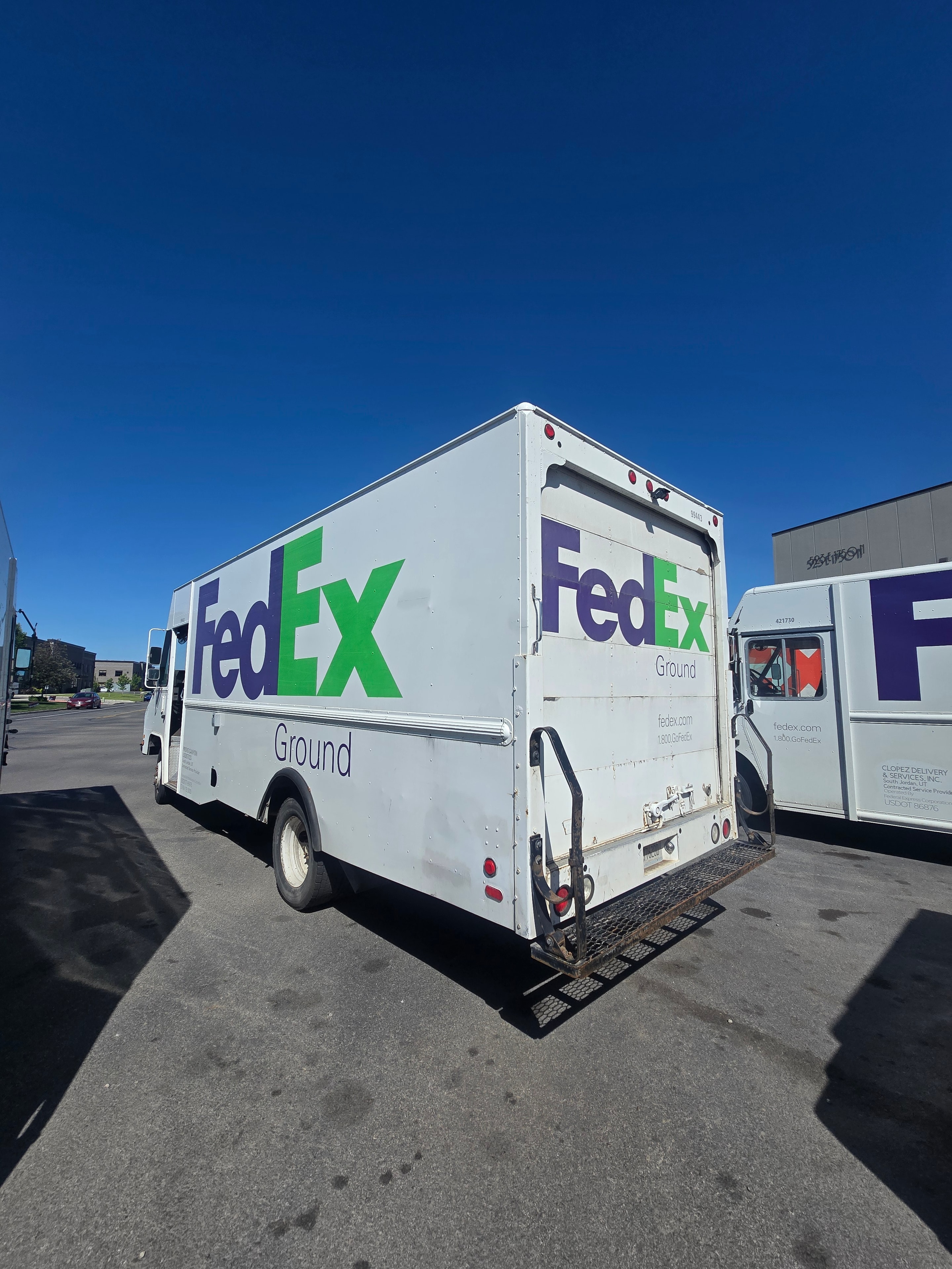 FedEx Ground step van — rear three-quarter view showing FedEx Ground graphics on box body before de-identification