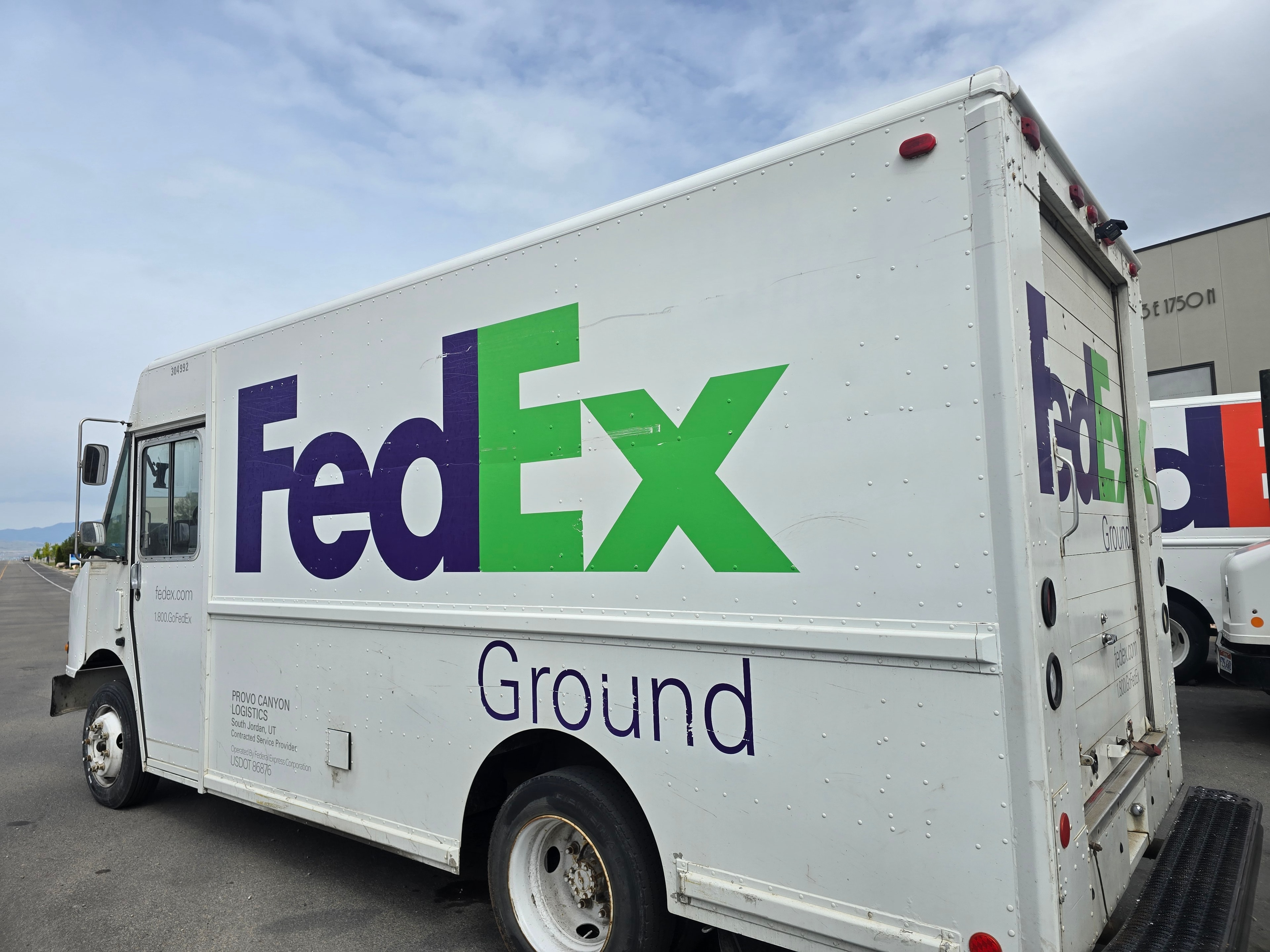 FedEx Ground step van — full driver-side panel with large FedEx Ground graphics before decal removal