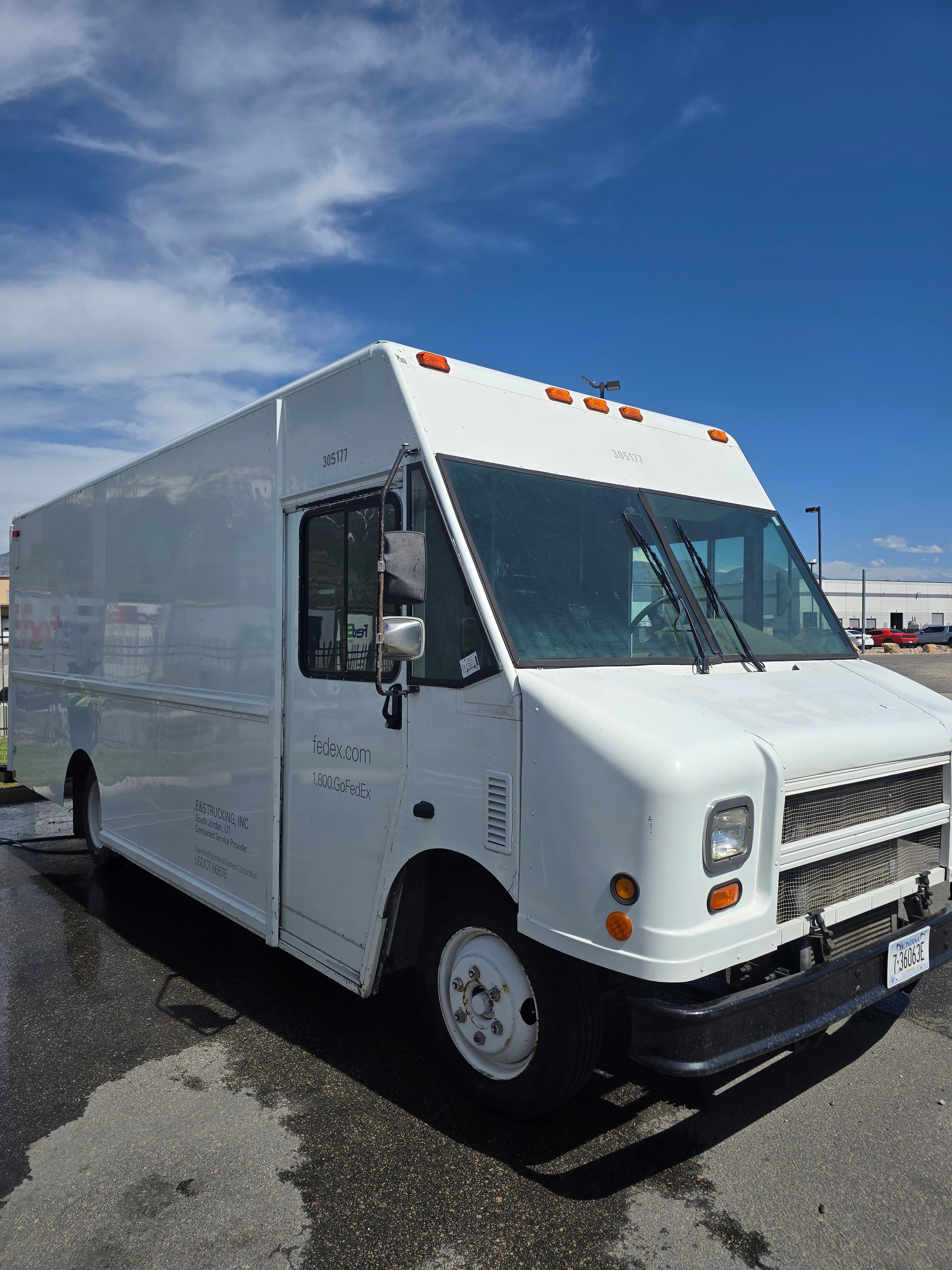 FedEx step van #305177 front face during de-identification — clean white cab panels after decal removal, Utah fleet rebranding project