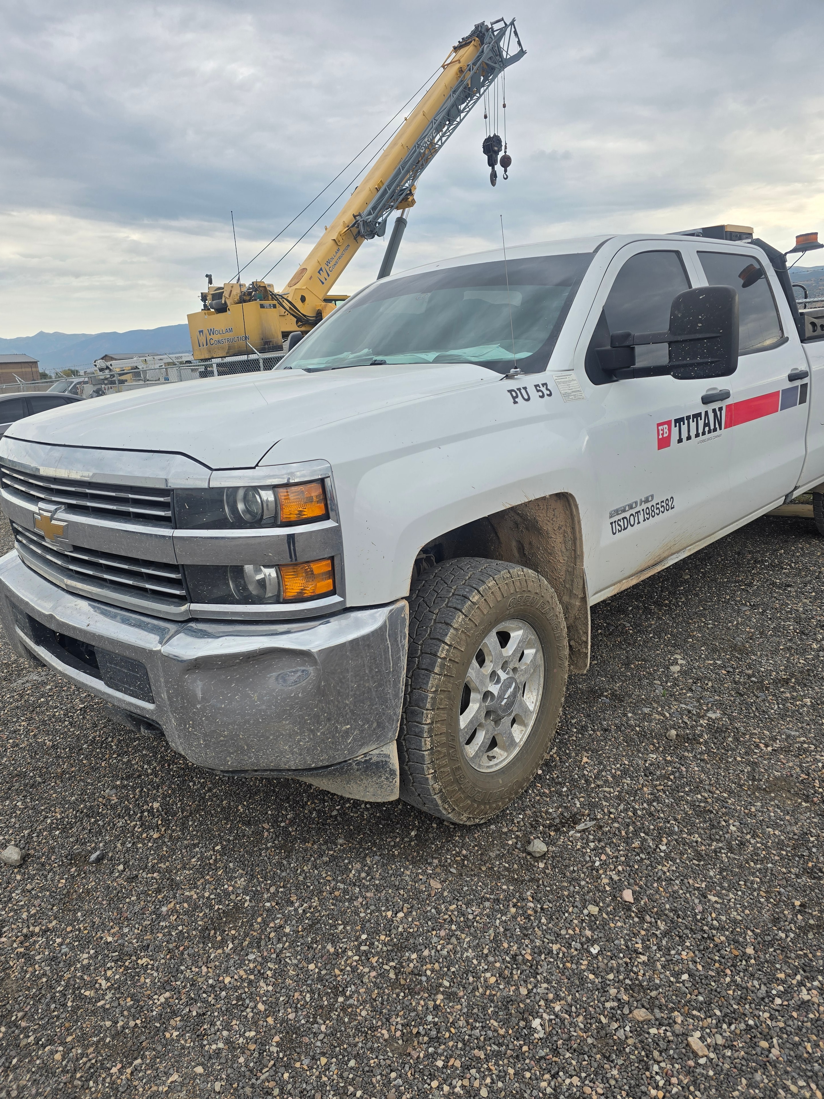 Titan pickup truck PU-53 front quarter before fleet washing — dust and grime from job sites