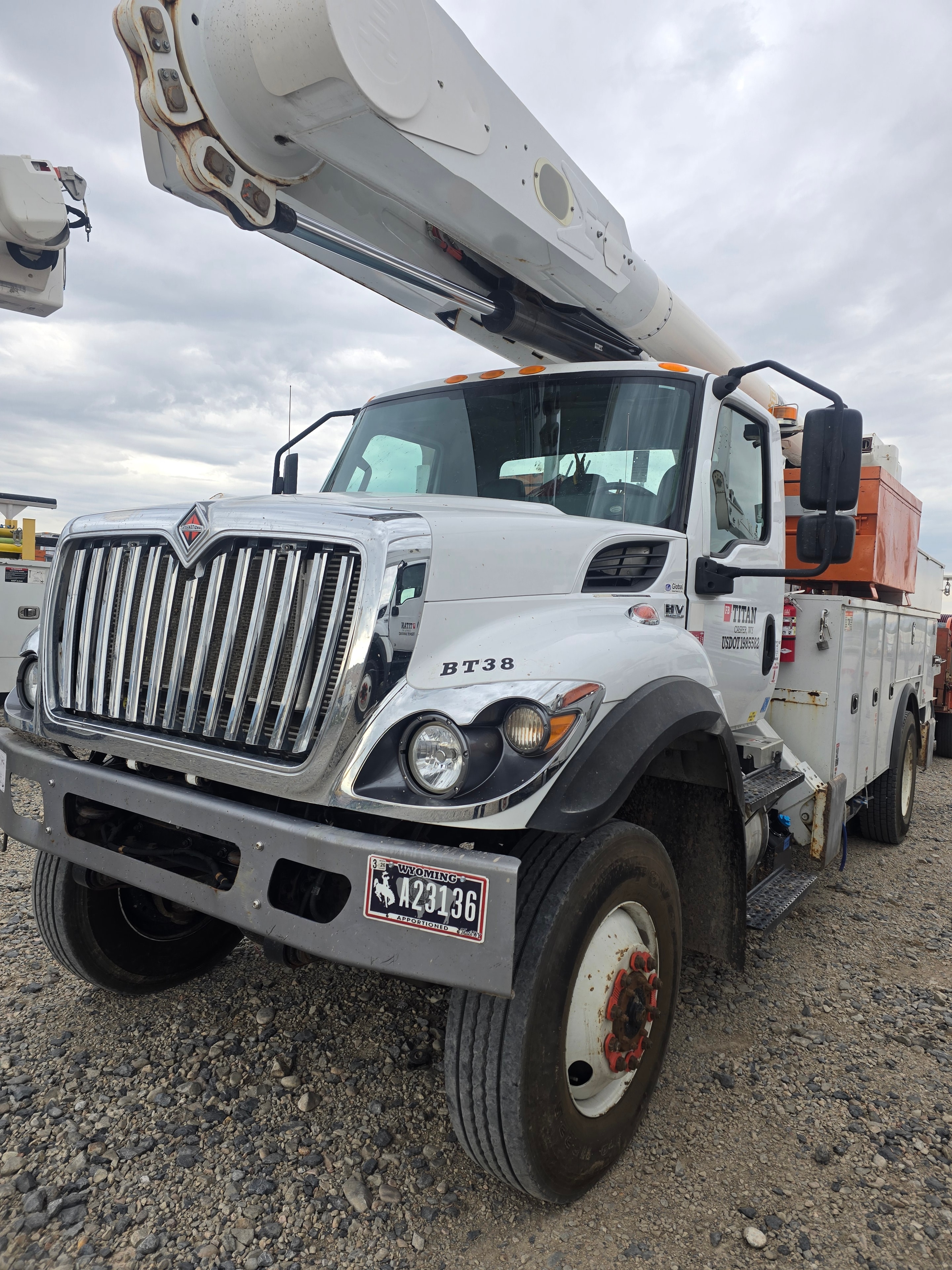 Titan Freightliner bucket truck BT38 before washing — heavy equipment grime and road film