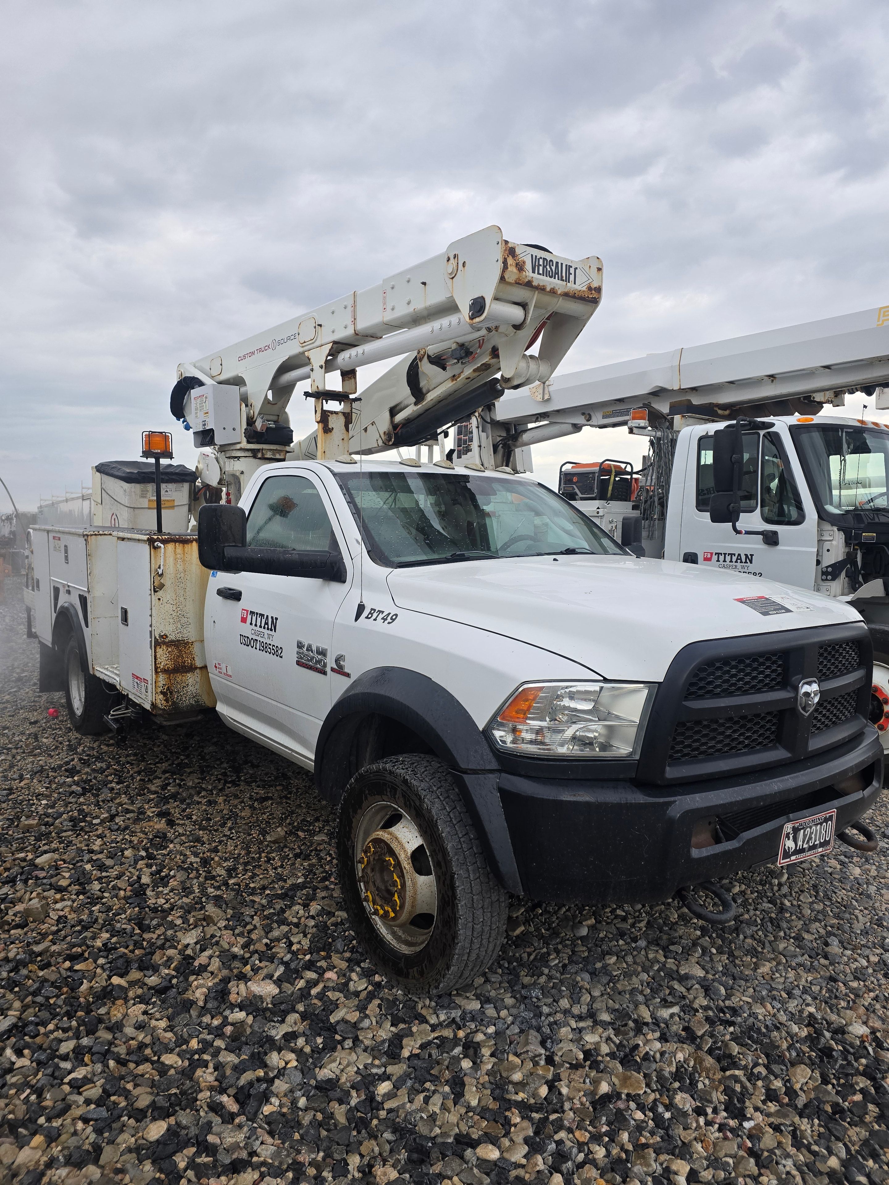 Titan Versalift bucket truck BT49 before washing — fleet of utility trucks before cleaning