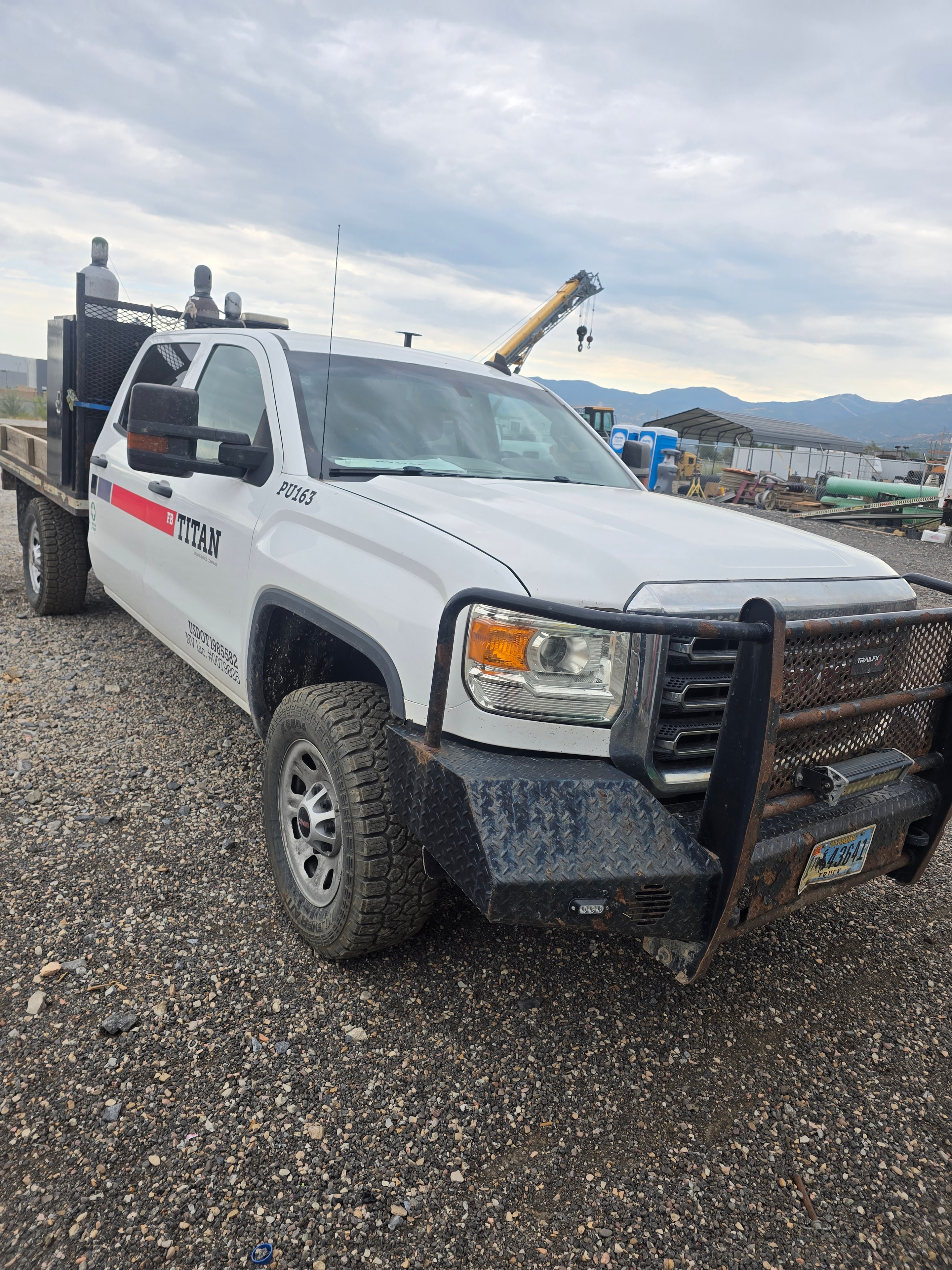 Titan pickup truck PU163 front quarter before washing — dust and field grime buildup