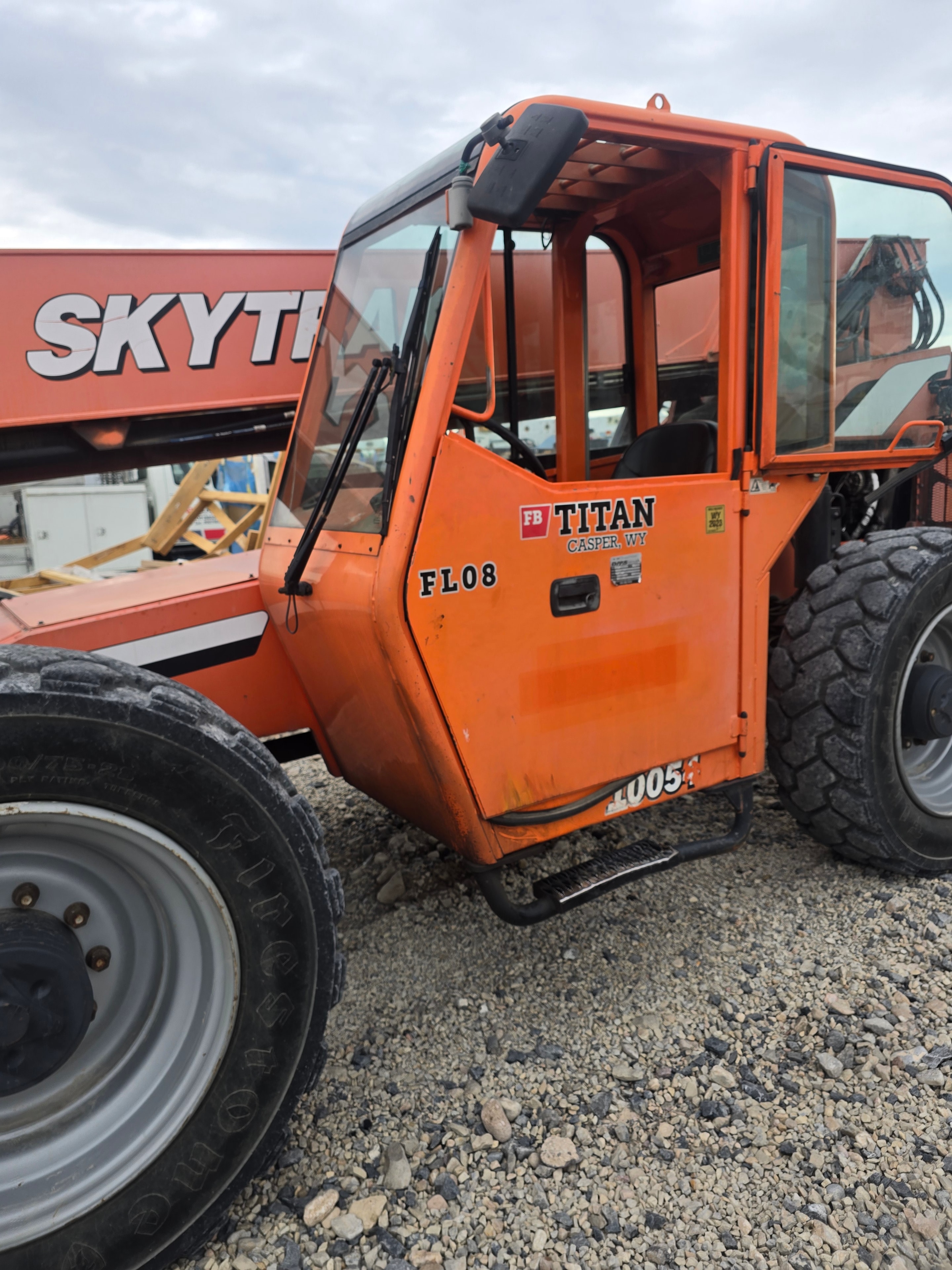 Titan Skytrak FL08 rough terrain forklift before washing — orange equipment with heavy contamination