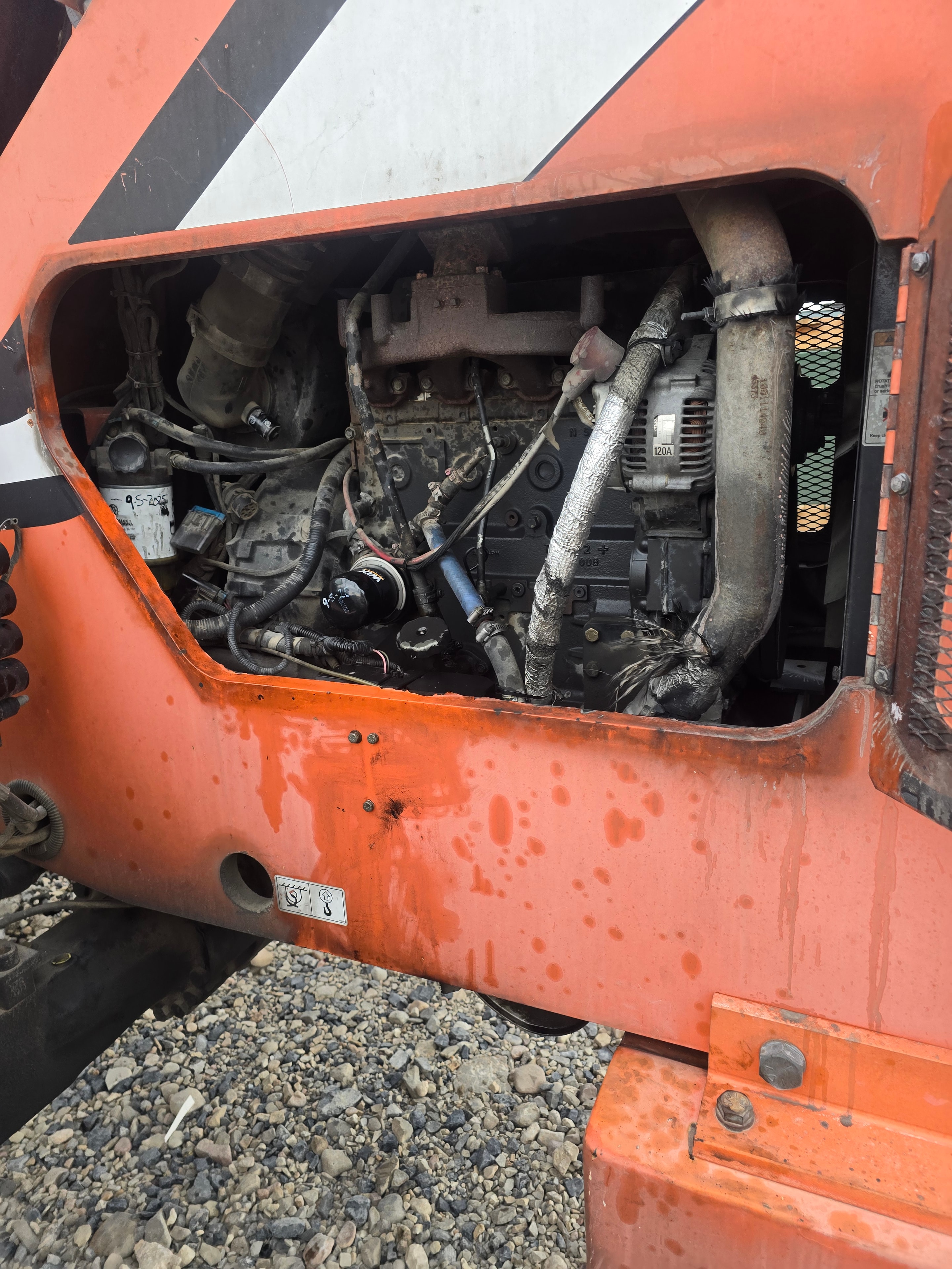 Titan Skytrak FL08 engine bay before cleaning — grease and hydraulic fluid buildup on components