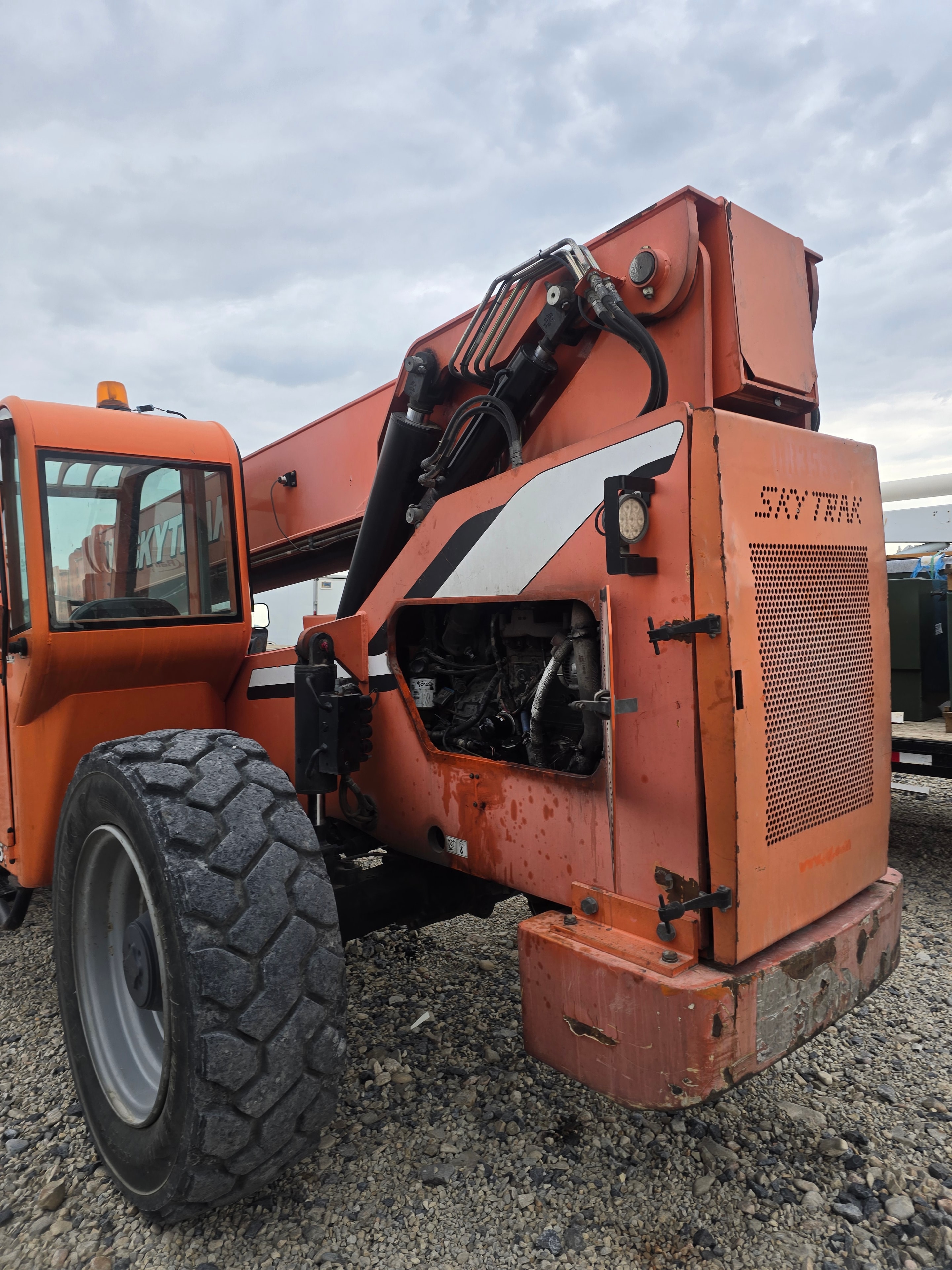 Titan Skytrak forklift rear before washing — hydraulic lines and heavy equipment grime