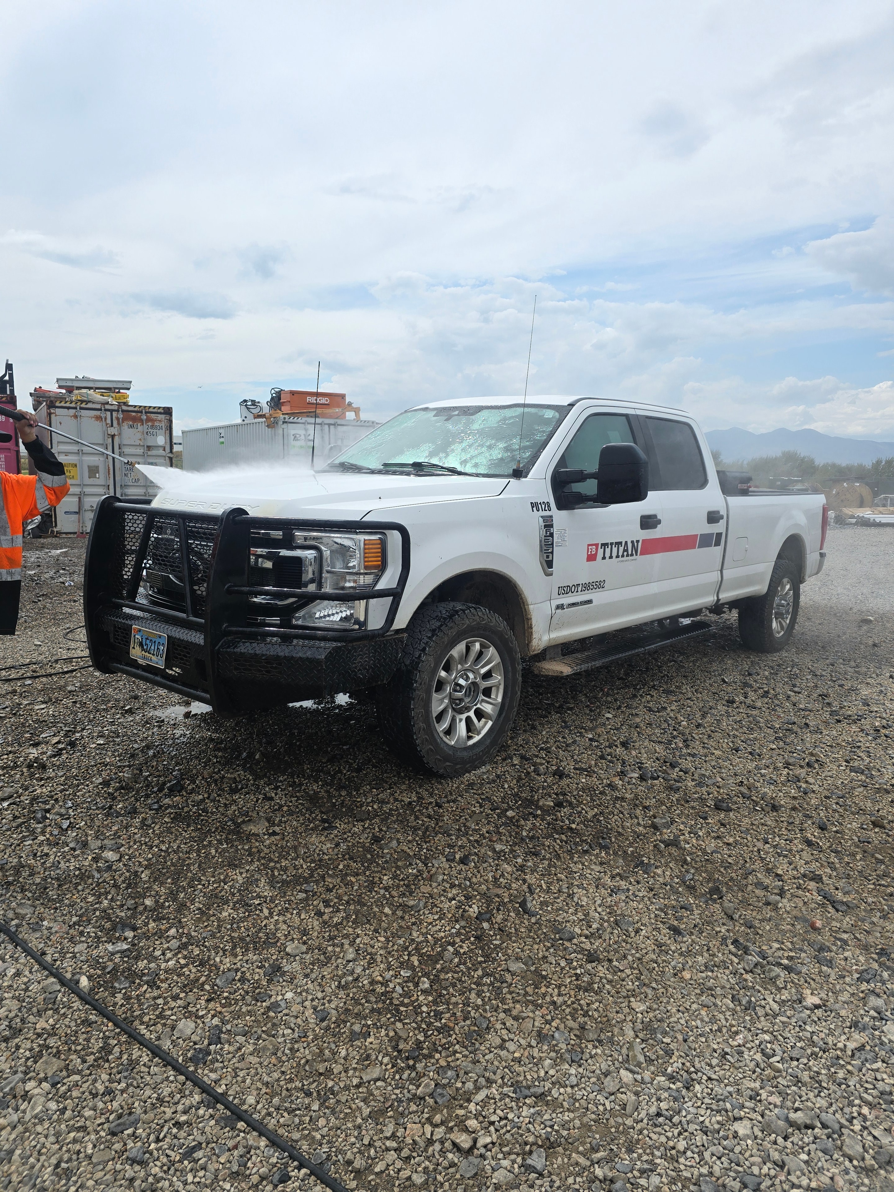 Power Stream USA technician washing Titan bucket truck on-site