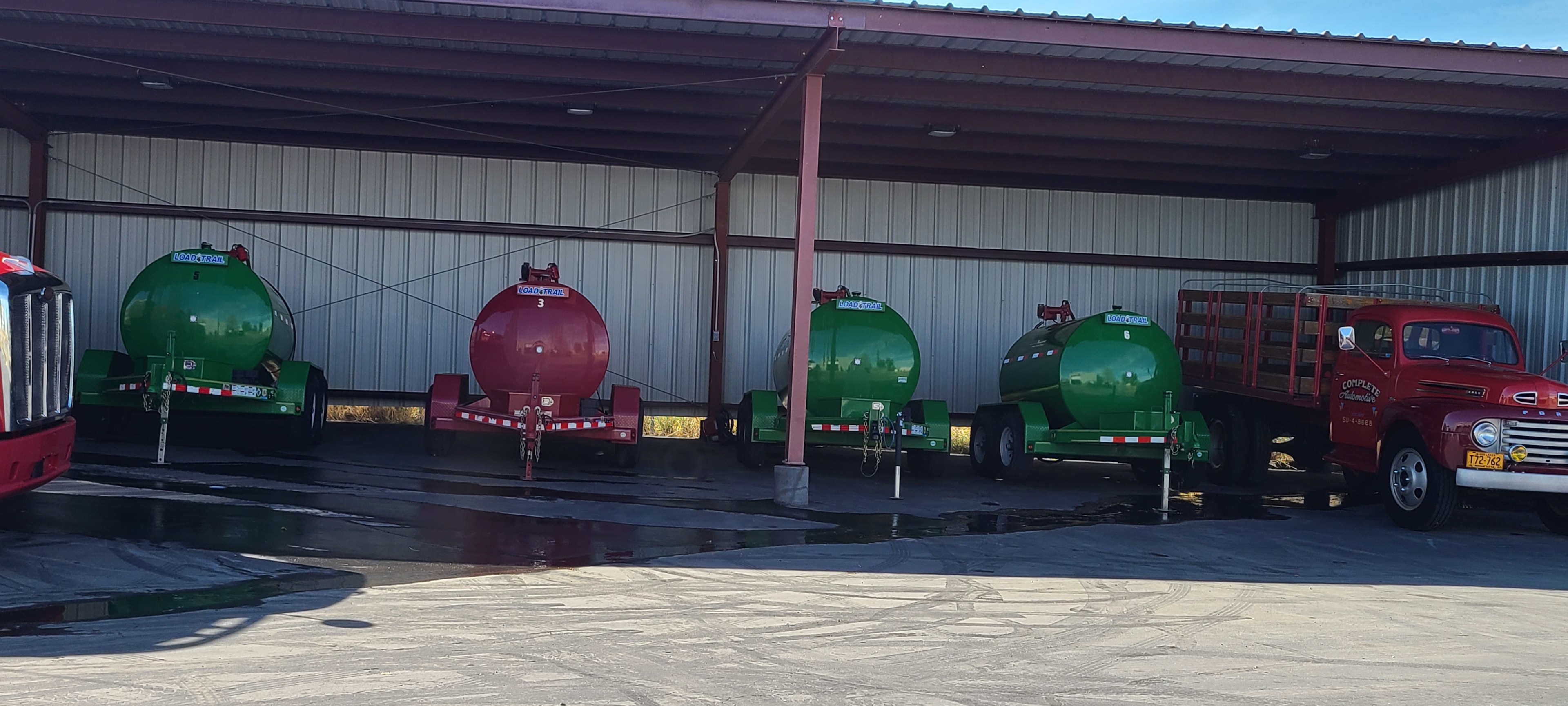 Load Trail tankers 3 and 6 — four fuel trailers after washing under covered bay, Salt Lake City Utah