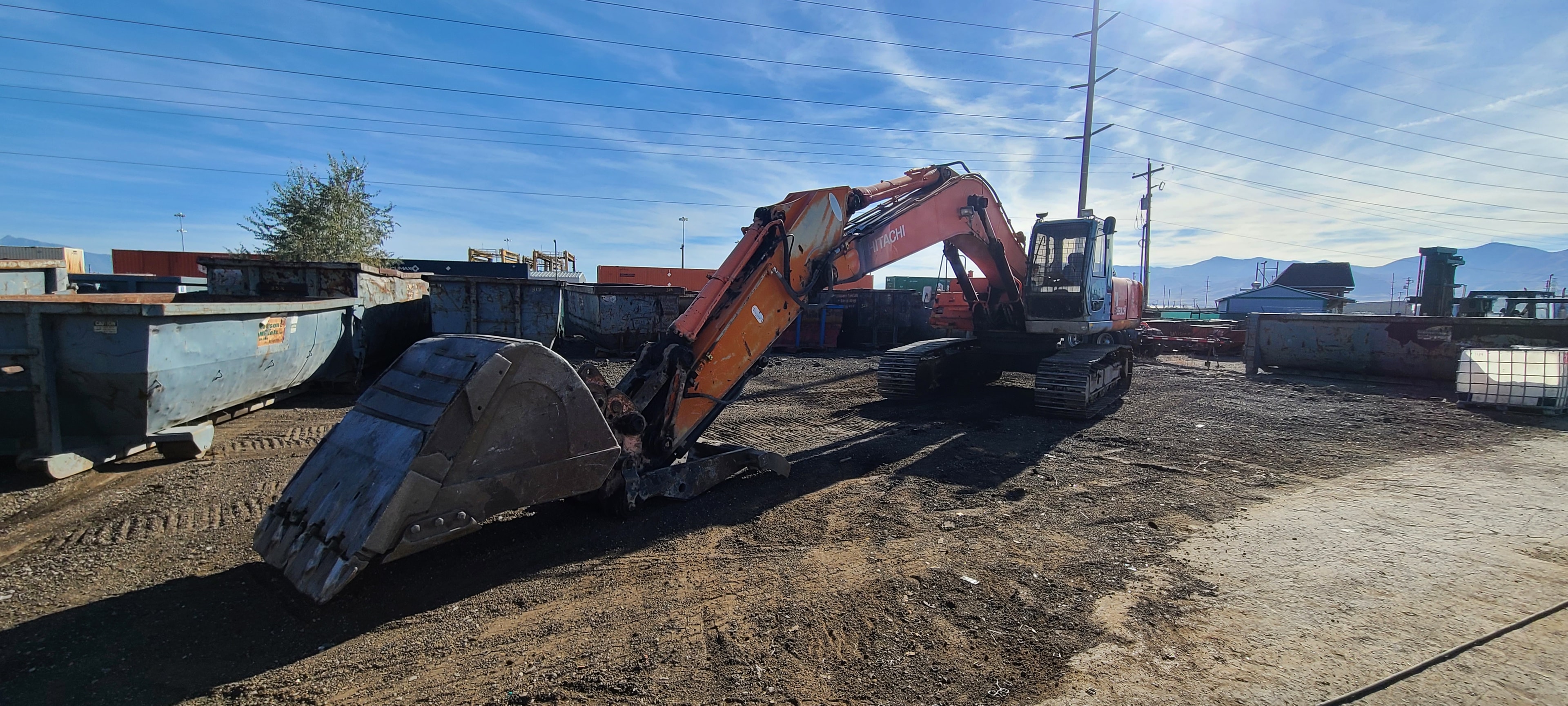 Hitachi excavator — compacted mud packed into tracks and undercarriage, Salt Lake City